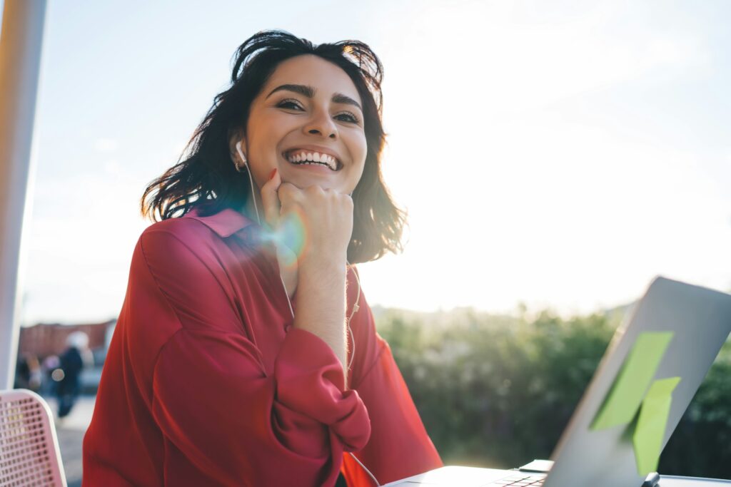 Happy female remote worker in summer terrace