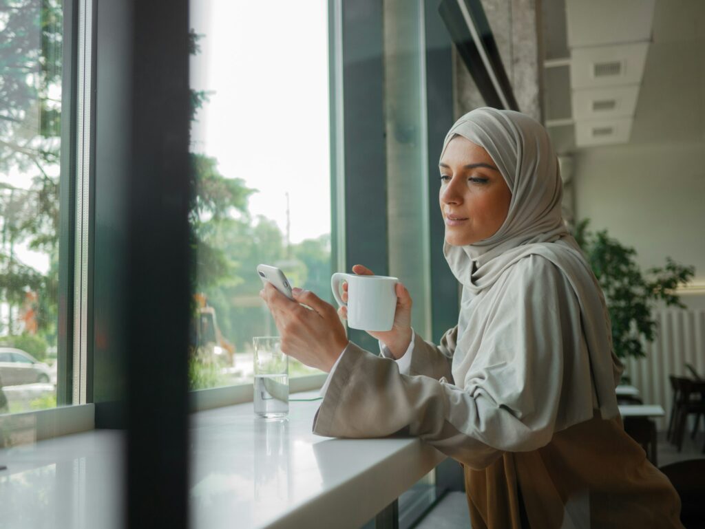 Muslim woman on remote working, online education or video conversation in caffe